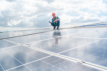 Fototapeta na wymiar Male engineering teams install solar panels at solar power generating station, Professional engineer installing photovoltaic panel system using screwdriver, green energy and sustainable living