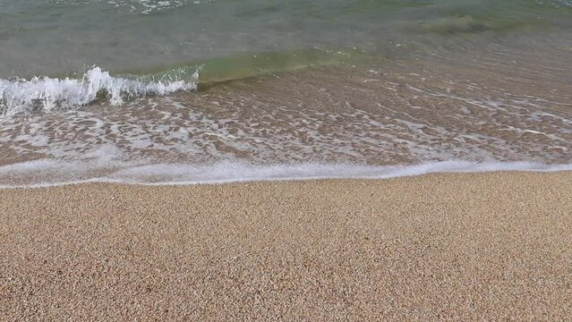 Wave and sand at the tropical beach. Beach slow motion video