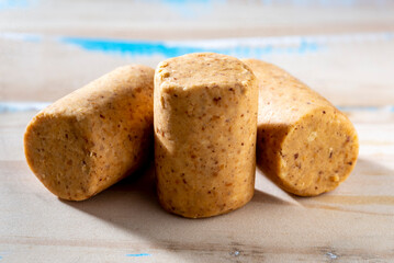 Round pressed paçoca on a rustic wooden table to remember june party