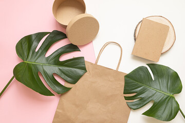 Flat Lay shopping concept with paper bag and tropical leaves. Elegant composition with elegant...