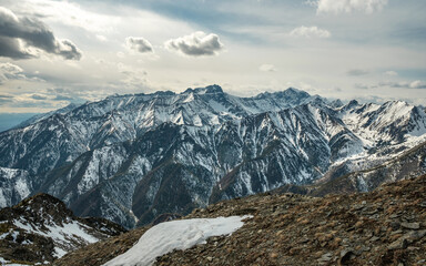 Landscape of snow-capped peaks of the rocky mountains in Sunny weather. Concept of nature and travel