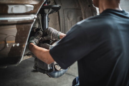 Car suspension repair and maintenance service in garage service shop.	