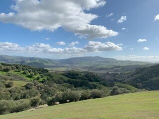 green hills with clouds