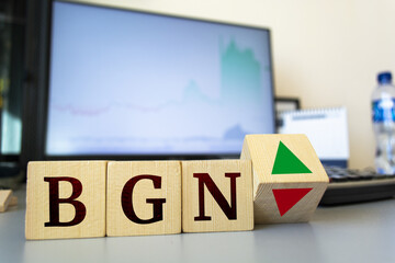 Wooden cubes with the inscription BGN and a cube symbolizing the rise and fall of financial markets