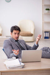 Young male employee working in the office