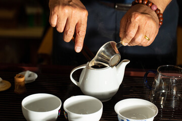 pouring tea into a teacup	