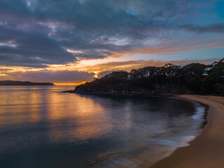 Fototapeta premium Aerial sunrise seascape with calm seas and a mix of high and low cloud