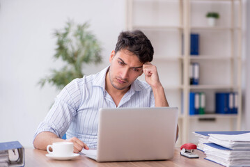 Young male employee working in the office