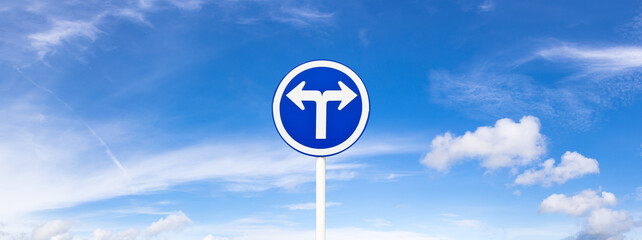 Road Traffic Sign over blue sky,turn left or turn right