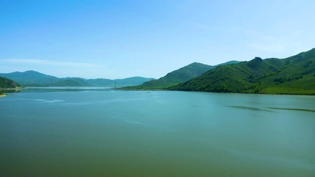 Aerial bird's-eye view of a huge reservoir among the mountains, bright sunny day, Bukhtarma reservoir, beautiful nature of east Kazakhstan