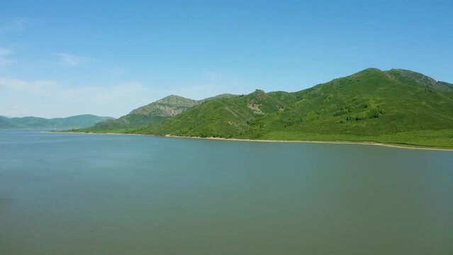 Aerial bird's-eye view of a huge reservoir among the mountains, bright sunny day, Bukhtarma reservoir, beautiful nature of east Kazakhstan