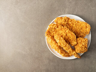 Pork cutlet and fried shrimp on a plate
