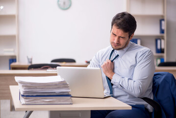 Young male employee working in the office