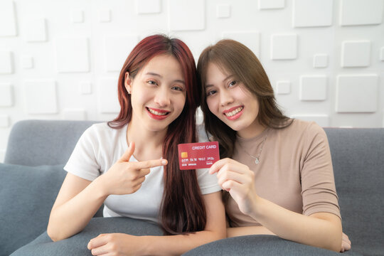 Portrait of smiling woman holding credit card. Smiling Female Recommending App For Internet Purchases, Mockup.