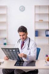 Young male doctor radiologist working in the clinic