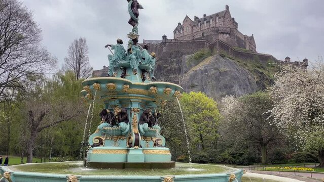 Wide view of Ross fountain on an overcast day in Princes Street Gardens in Edinburgh, Scotland, UK. Panning up the fountain to show Edinburgh Castle.