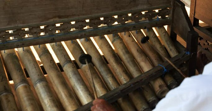 Slow motion static shot of Rindik an instrument made of bamboo canes from bali indonesia in ubud while music is played