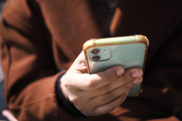 close up of women hand holding smart phone 