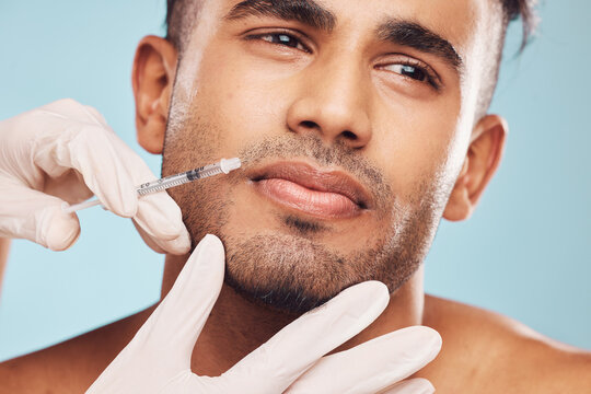 Beauty, botox and mouth with a man in studio on a gray background for a plastic surgery injection. Hands, skincare and syringe with a young male patient indoor for an antiaging facial filler closeup
