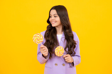 Teenage girl with lollipop, child eating sugar lollipops, kids sweets candy shop. Excited teenager girl. Happy teenager, positive and smiling emotions of teen girl.