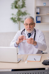 Old male doctor suggesting pills in the clinic