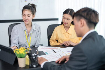 Business group meetings and corporate discussion about last year's review and a new business plan in the office.Talking and planning work happily and have fun. at the company's office
