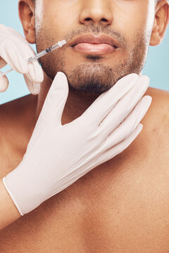Skincare, botox and lips with a man in studio on a gray background for a plastic surgery injection. Hands, beauty and syringe with a young male patient indoor for an antiaging facial filler closeup