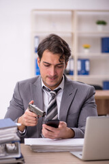 Young male employee unhappy with excessive work in the office