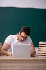 Young male student sitting in the classroom