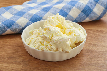 Italian soft mascarpone cheese in the bowl