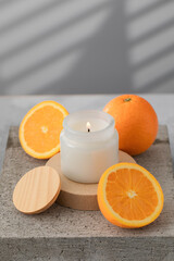 White interior candle in glass with orange fragrance. Handmade candle. Hugge