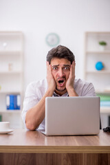 Young male employee working in the office