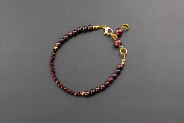Garnet gemstone bracelet, unique handmade stone bead jewelry background, promotional photo for an online jewellery store