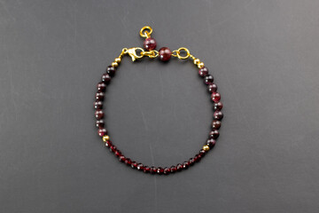 Fototapeta na wymiar Garnet gemstone bracelet, unique handmade stone bead jewelry background, promotional photo for an online jewellery store