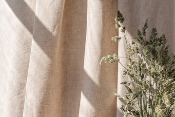 Aesthetic boho neutral floral background, abstract sunlight shadows on beige linen curtain and...