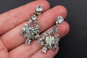 Vintage rhinestone earrings close up, retro jewelry concept, promotional photo for an online jewelry store