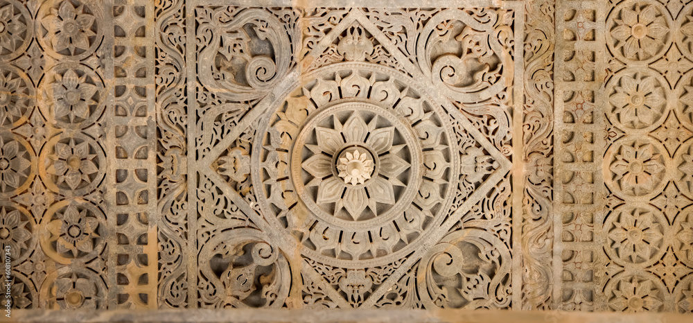 Wall mural intricate architectural detail and sculpture of historic jain temple in ranakpur, rajasthan, india.