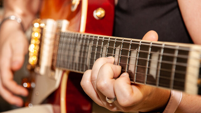 Woman plays beautiful electric guitar