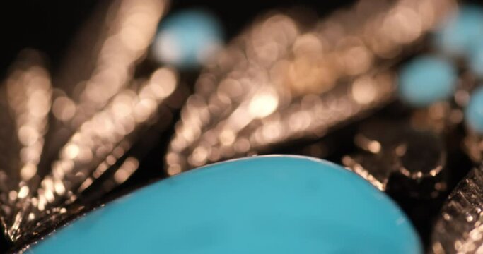 A macro shot of a blue gemstone showcases its exquisite and intricate details, unveiling a world of beauty within. The close-up view reveals the mesmerizing patterns, textures, and color 