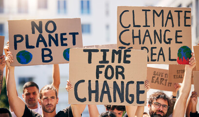 Group, poster and together in street for planet, climate change and sustainable future in city. People, cardboard sign and activism for change, sustainability or justice for environment in metro road