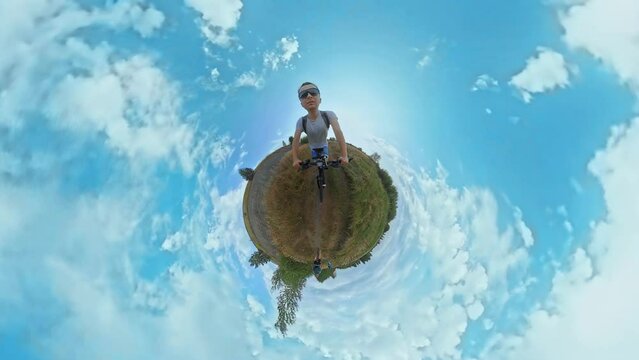 Trip journey of Caucasian bicyclist 30 year old with cross-country mountain bike. 360 degrees action camera shot with tiny planet projection, Fisheye lens, visual distortion. Third-person view. Sports
