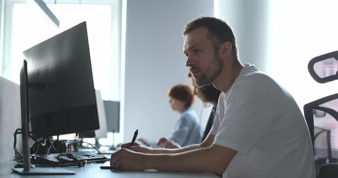 man in white t-shirt and women soft ware developers working at big city IT office. Man working with tablet, it designer. High quality 4k footage