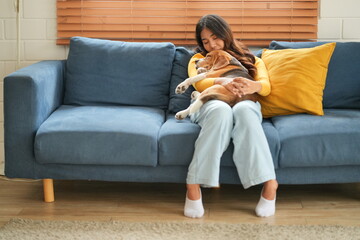 Furry friends. Embracing the pet. Woman with pug dog is at home at daytime