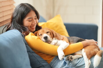 Furry friends. Embracing the pet. Woman with pug dog is at home at daytime