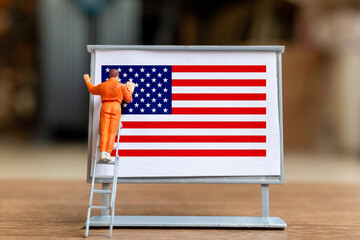 Worker paint on a billboard celebration of the Fourth of July and Independence Day