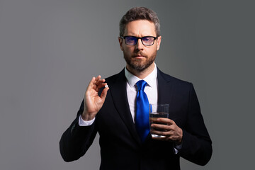 Man taking a medicine pill from headache migraine. Business man in suit is tired got headache migraine. Headache pain concept. Painful men are stressed. Stressful and headache.