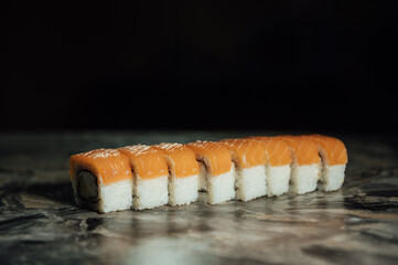 Traditional delicious fresh sushi roll set on a gray background without reflection.