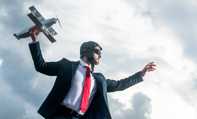 businessman in suit and aviation hat launch plane toy