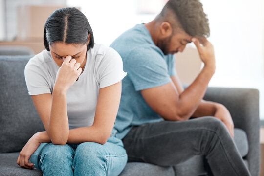 Couple, marriage fight and woman feeling sad and depressed on living room sofa with relationship problem. Divorce talk, cheating anxiety and crisis of young people on a lounge couch at home thinking