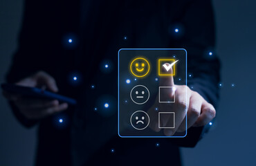Satisfaction rating and customer service concept, businessman hand selecting satisfaction icons through a virtual screen.